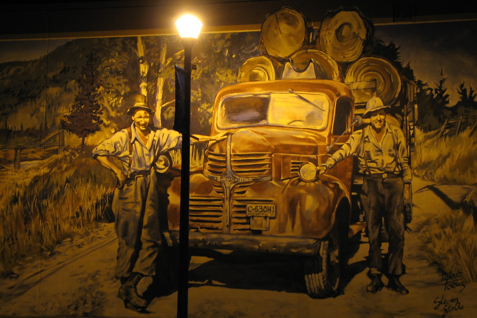 Fruitvale BC mural depicting an old loaded logging truck with 2 workers